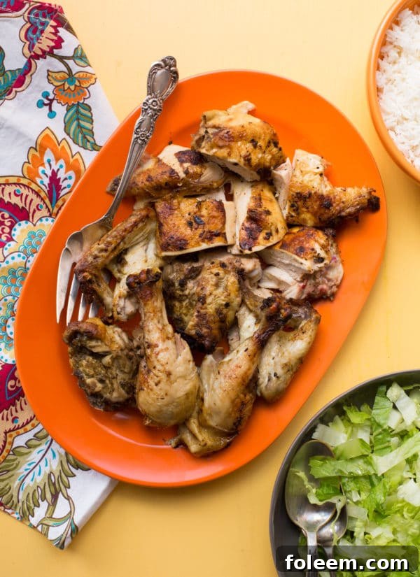 Cut up Rotisserie Chicken on an orange platter.