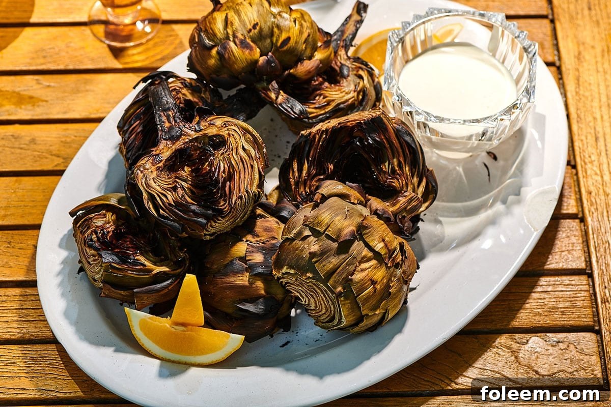 Grilled Artichokes with lemon sauce on plate