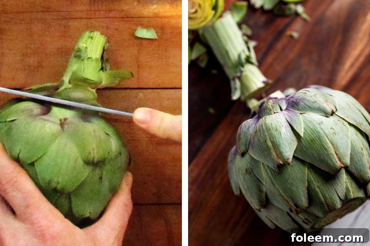 Cutting stem off fresh artichoke with knife on wood board.