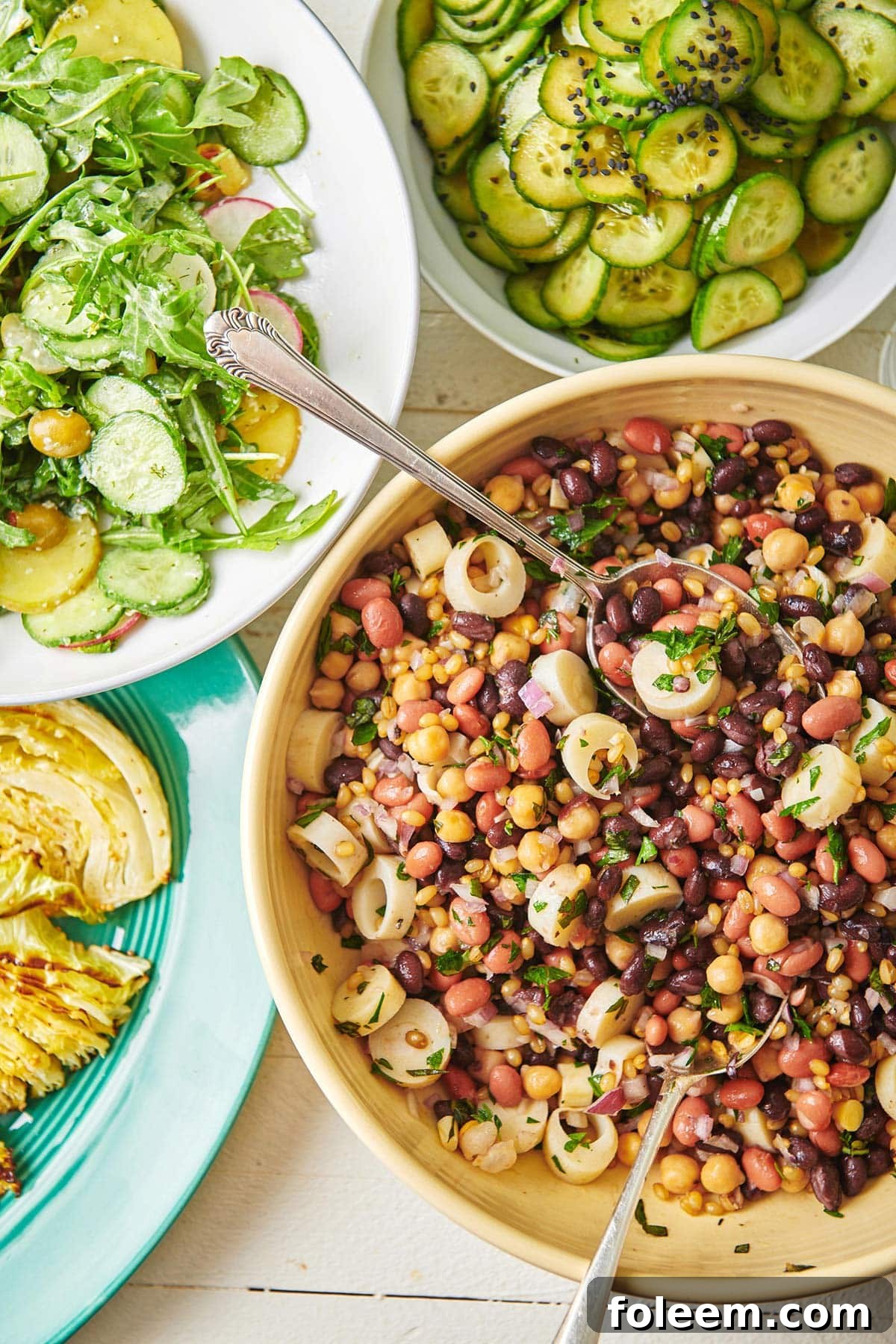 Modern Three Bean Salad on a table with other salads.