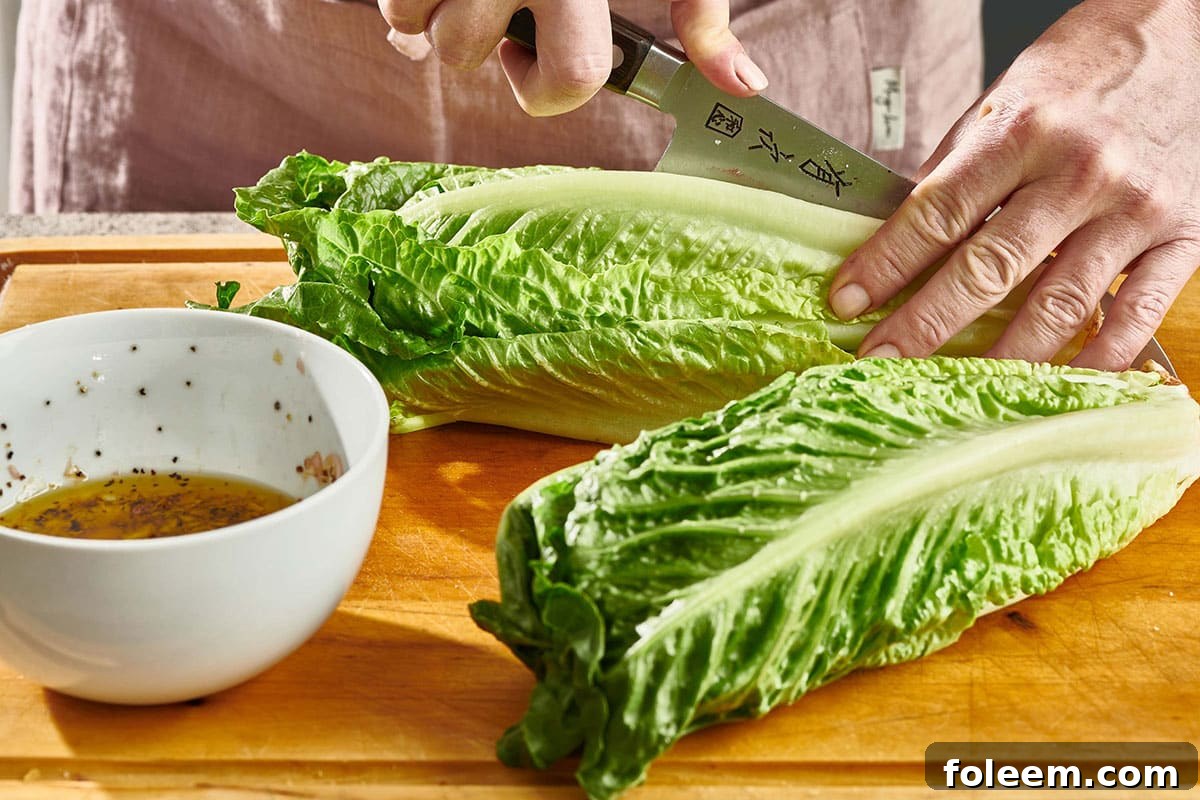 Woman slicing a head of Romaine.