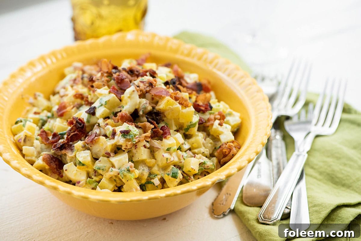 Yellow bowl of Egg and Potato Salad with Bacon.