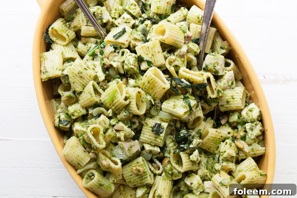 Chicken Pasta Salad with Ramp Vinaigrette in yellow serving dish.