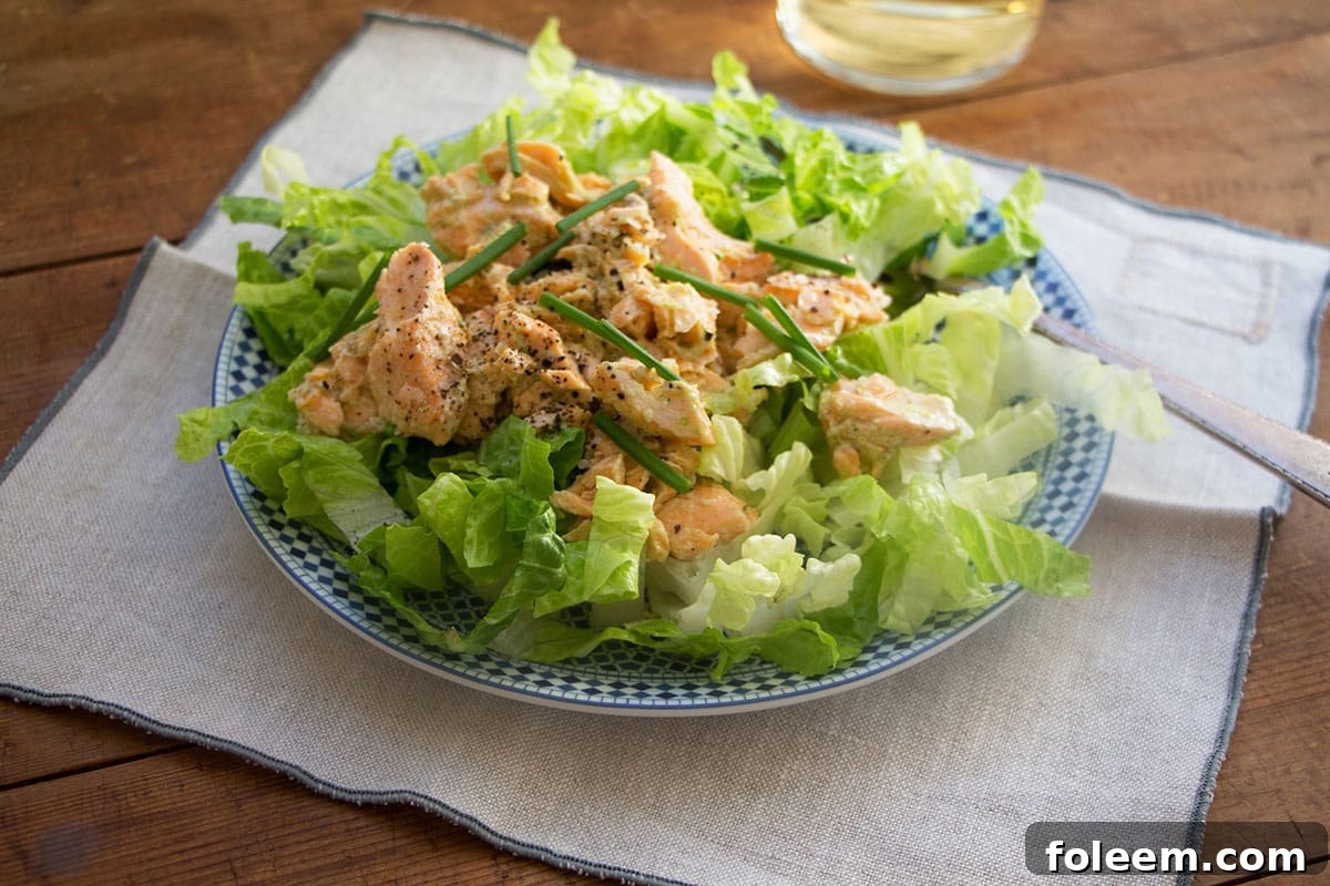 Salmon Salad with Jalapeno Scallion Dressing on a blue and white plate.