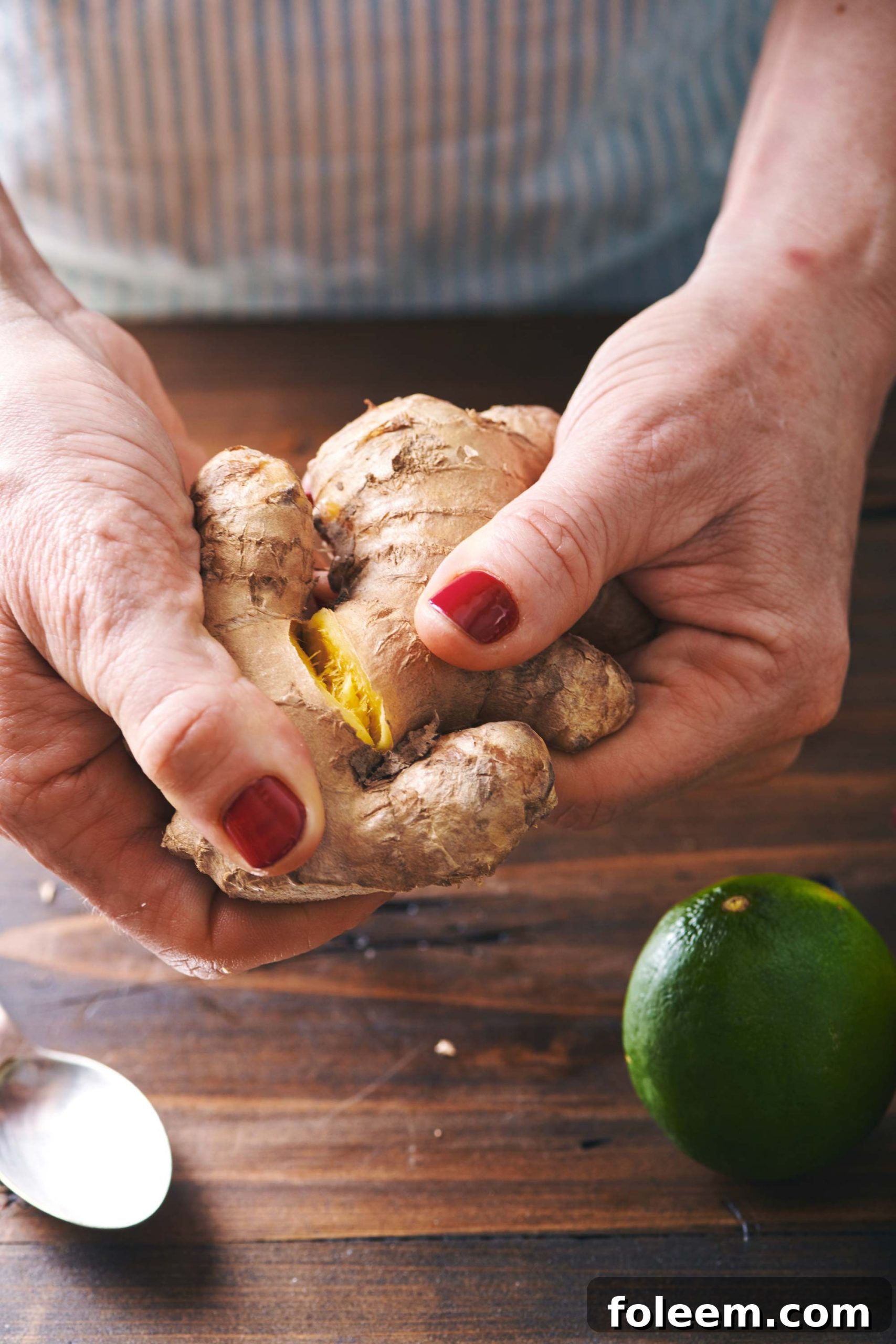 Woman holding fresh ginger root.