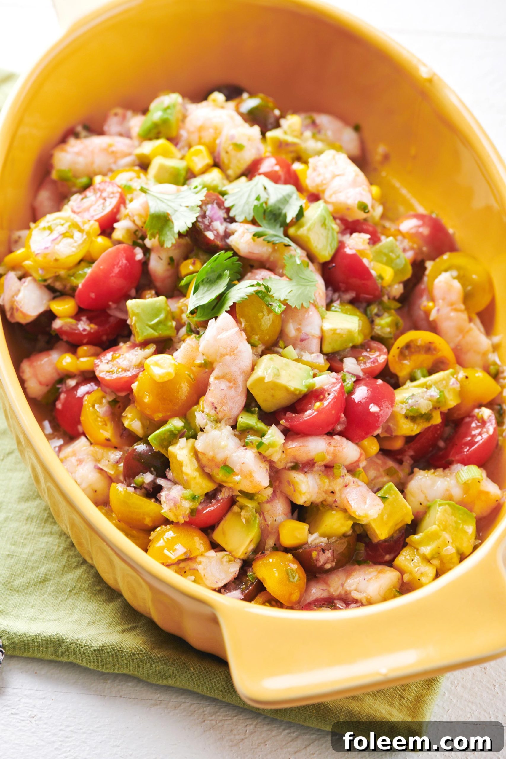 Orange dish of Shrimp and Avocado Salad.