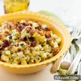 Yellow bowl of Egg and Potato Salad with Bacon.