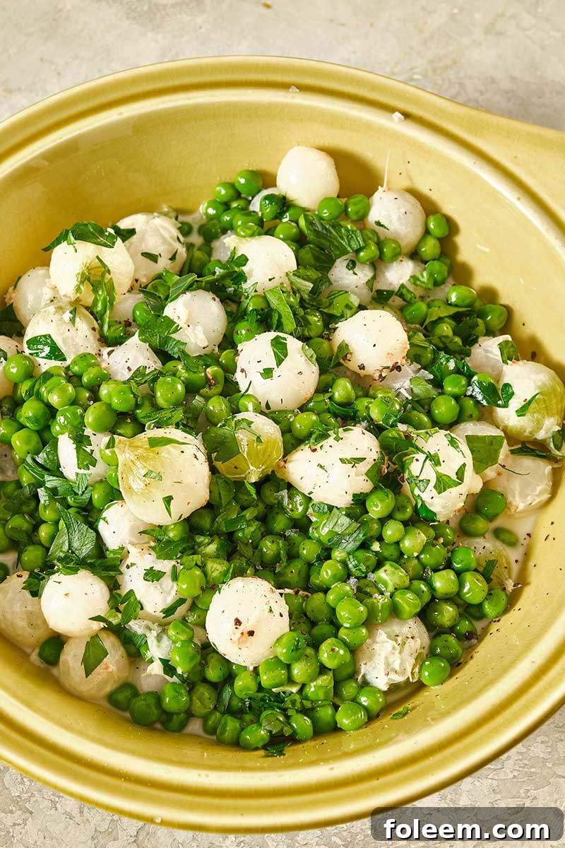 Creamed Peas and Pearl Onions in yellow bowl.