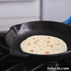 Tortilla in a skillet on a stovetop.