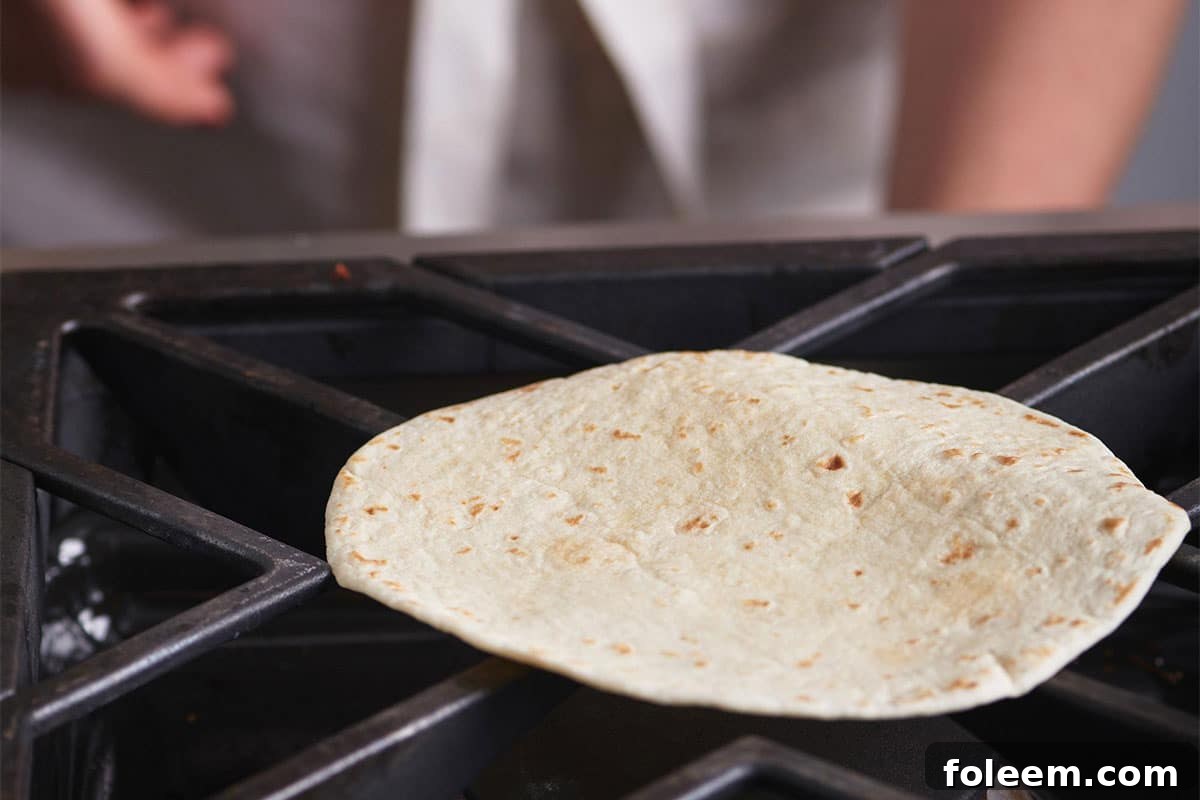 Tortilla warming directly on a gas stove.