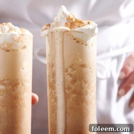 Two Iced Pumpkin Spice Lattes in tall glasses.