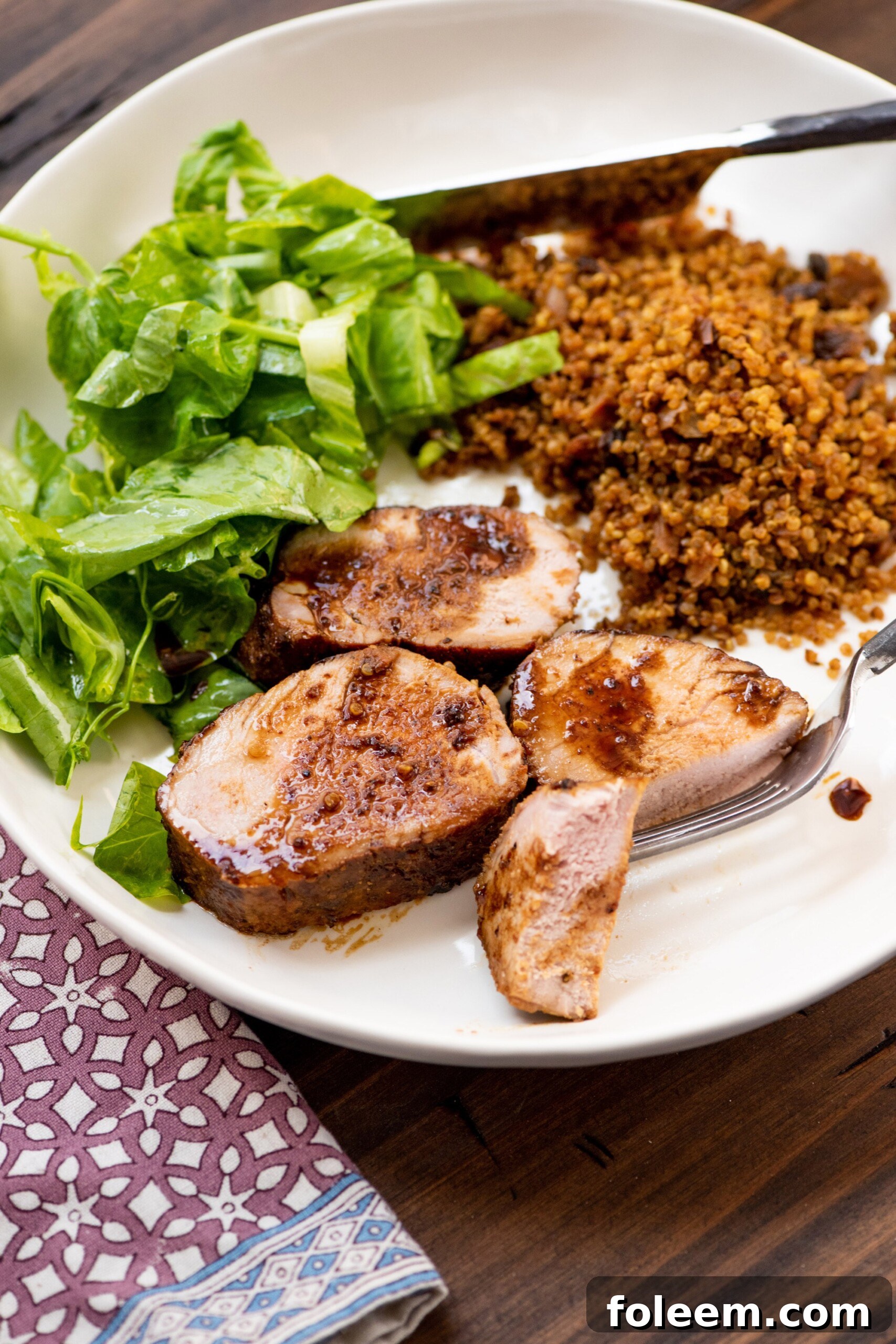 Dijon and Honey Crusted Pork Tenderloins on white plate.