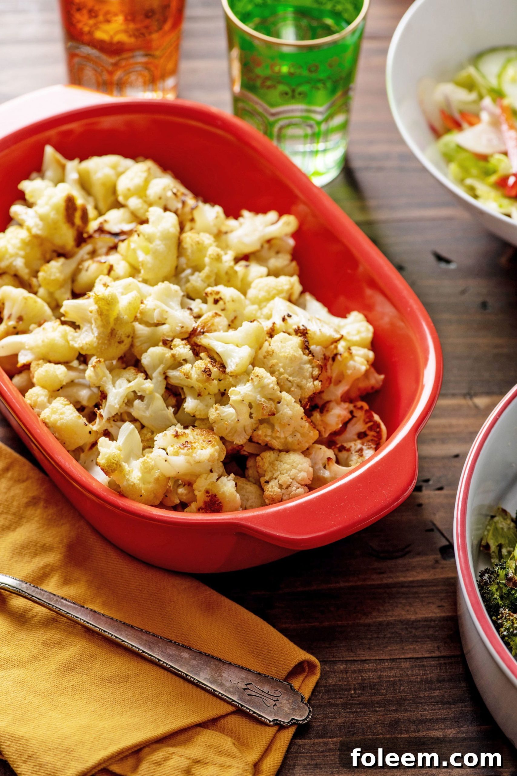 Roasted cauliflower in red bowl.