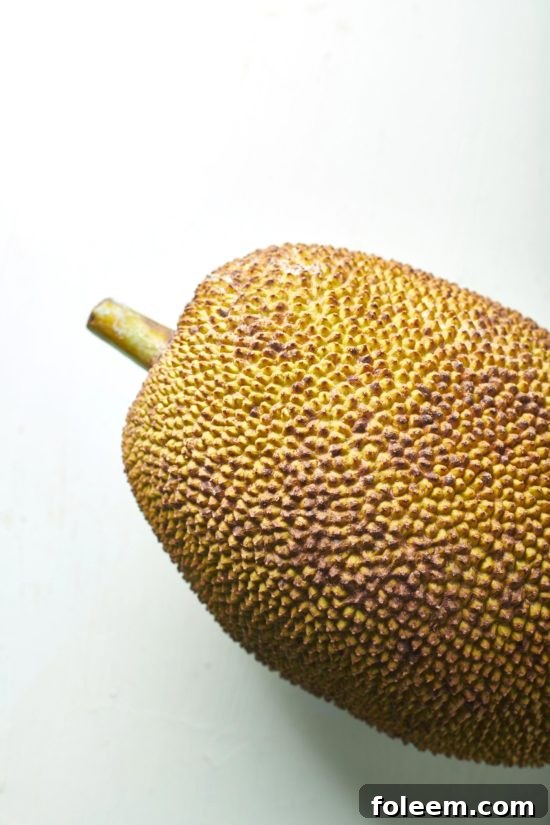 Whole jackfruit on a white table.