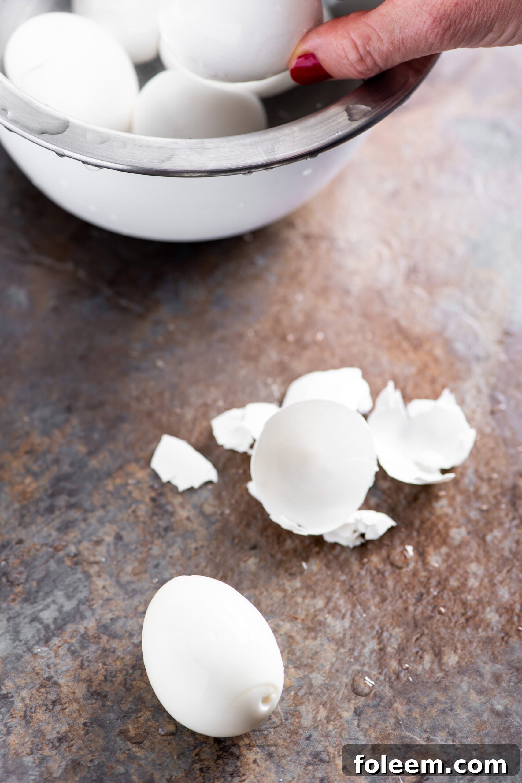 Woman holding hard boiled egg.