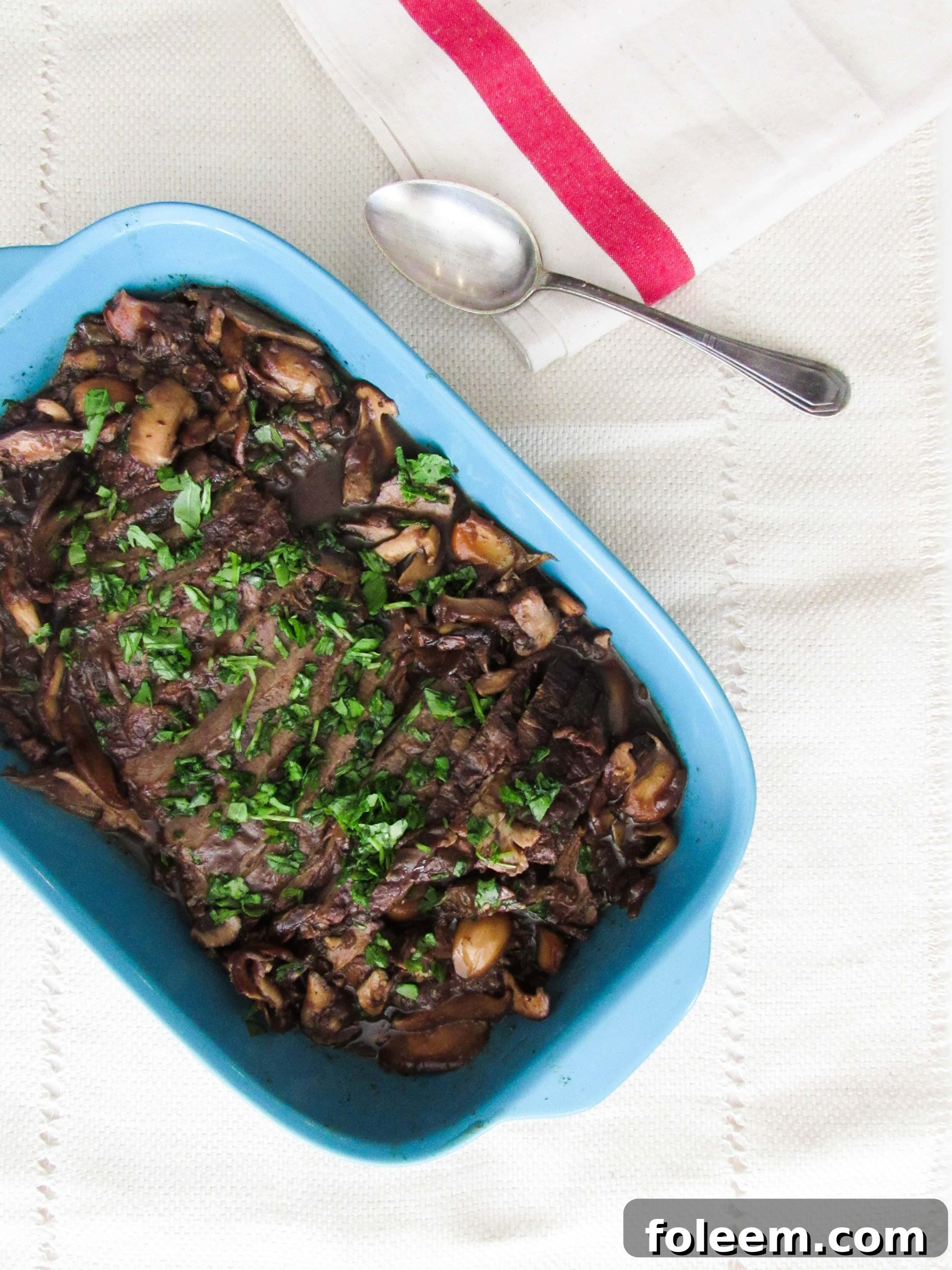 Beef Brisket with Wild Mushrooms in blue baking dish.