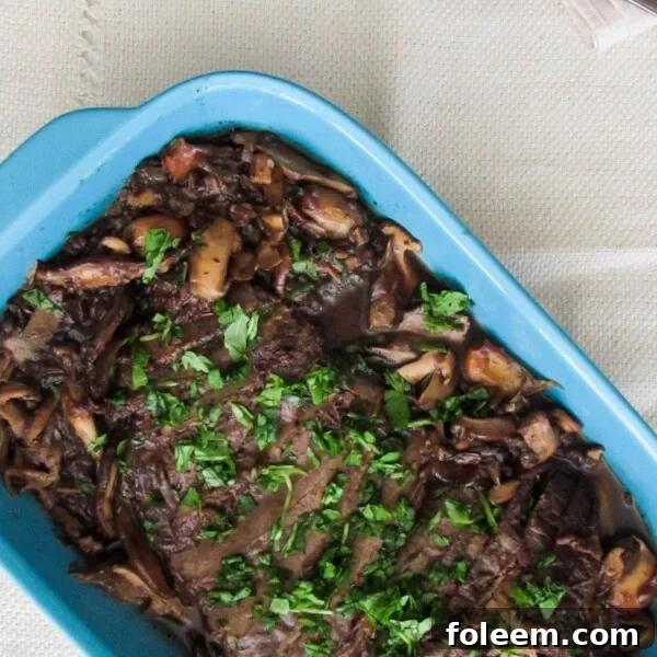Beef Brisket with Wild Mushrooms in blue serving dish.