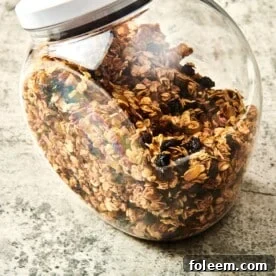 Granola in a see-through container with a lid.
