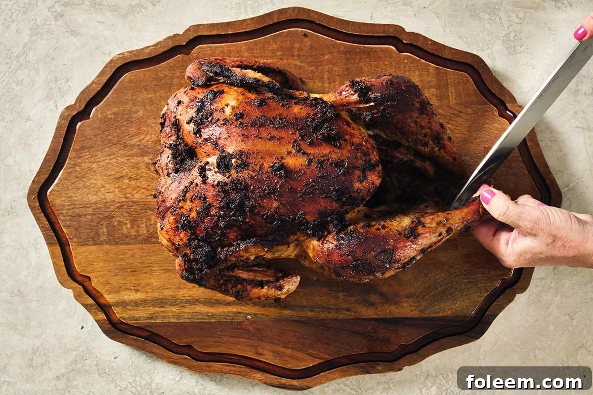 Carving a Cajun Roasted Turkey on wood cutting board.