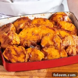Red baking dish of Candied Sweet Potatoes.