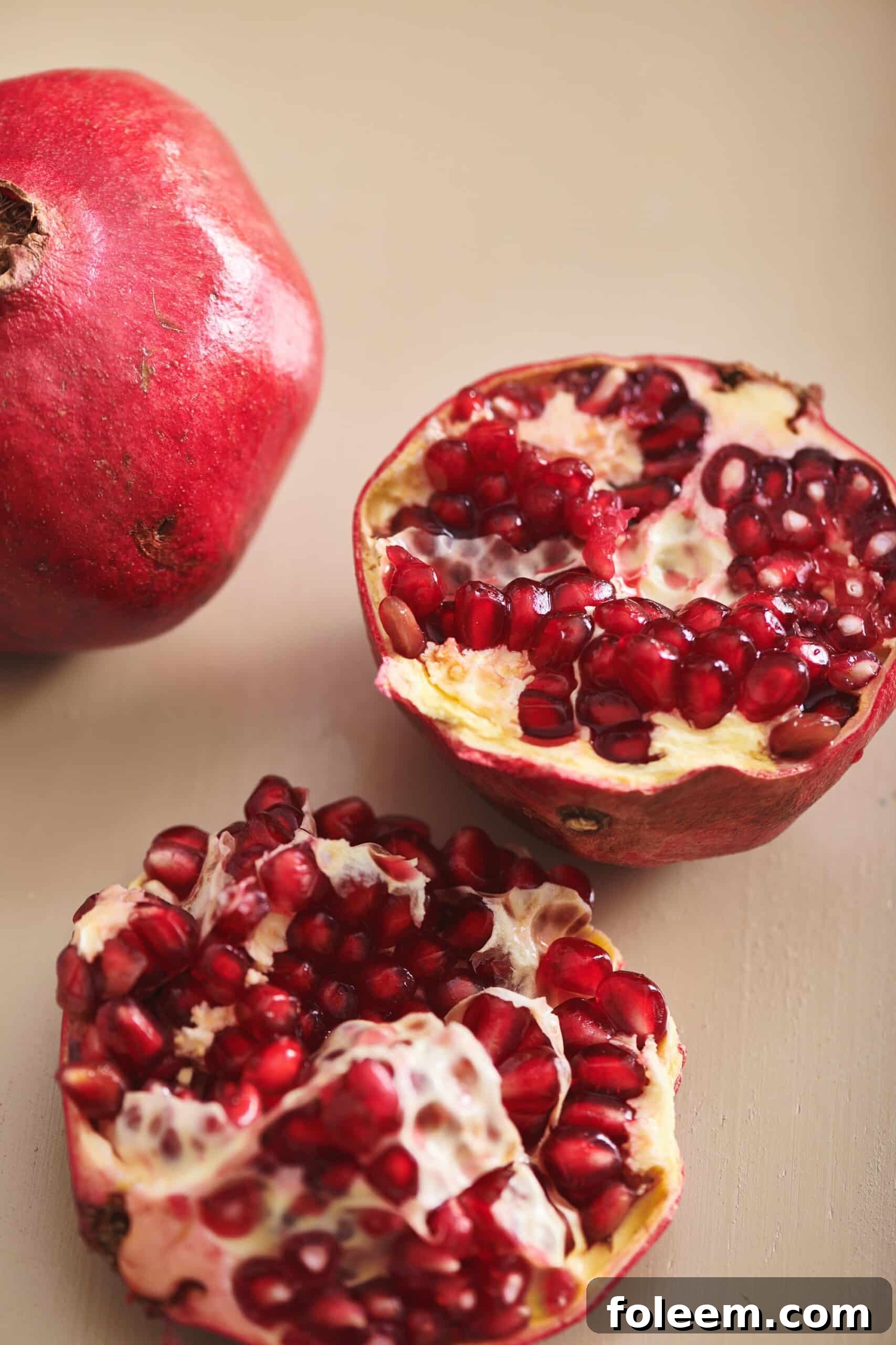 Fresh pomegranate cut in half on table.