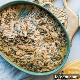 Hot Creamy Mushroom and Spinach Dip in a bowl and on crackers.