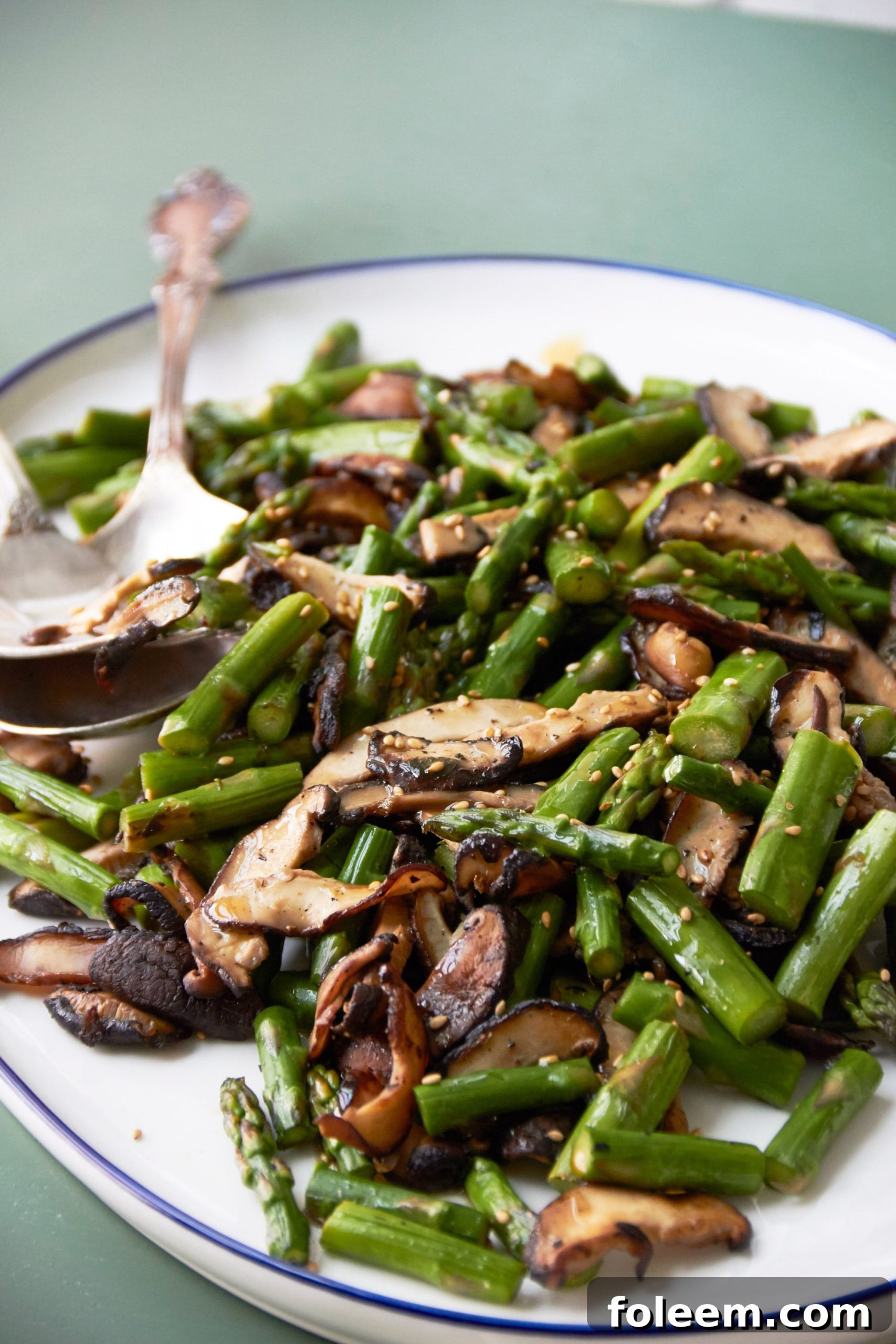 Serving dish piled high with Asparagus and Mushroom Stir-Fry.