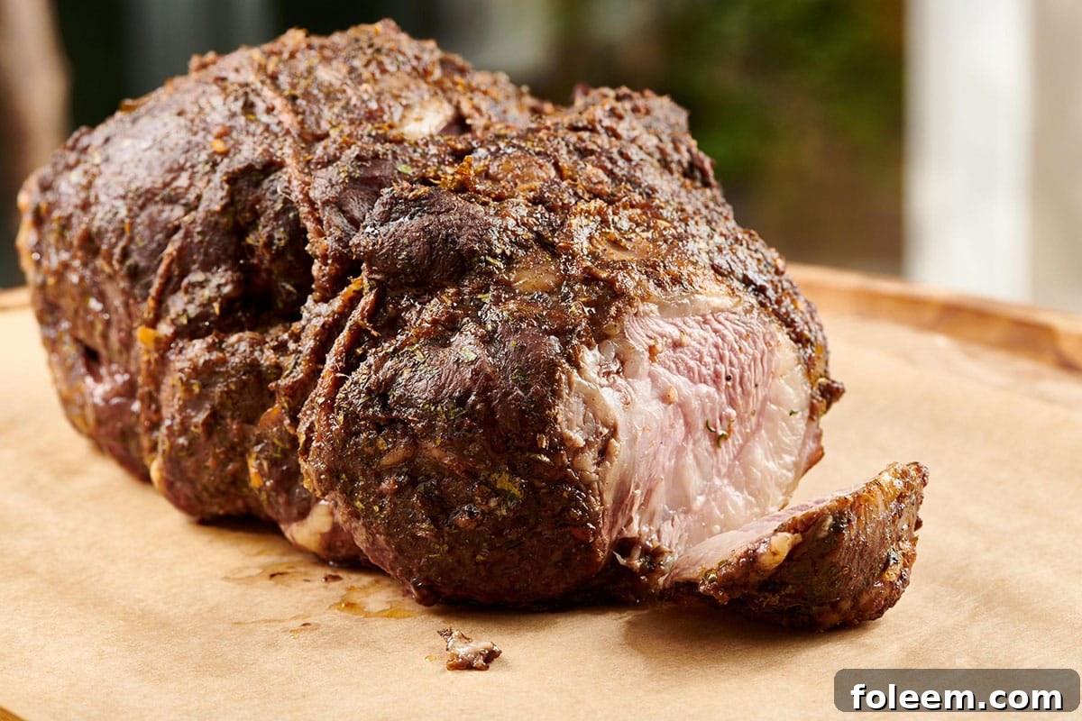 Slow Cooked Moroccan Leg of Lamb on cutting board.
