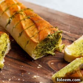 Garlic Bread filled with persillade sauce on cutting board.
