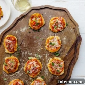 Mini Pizzas on a wooden surface.