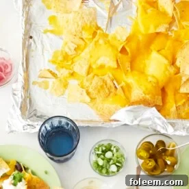 Nachos and toppings on table.