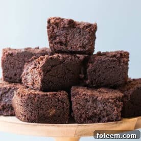 Stack of hot chocolate brownies on wood platter.