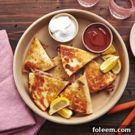 Tray of Pulled Pork Quesadillas, dips, and lemon wedges.