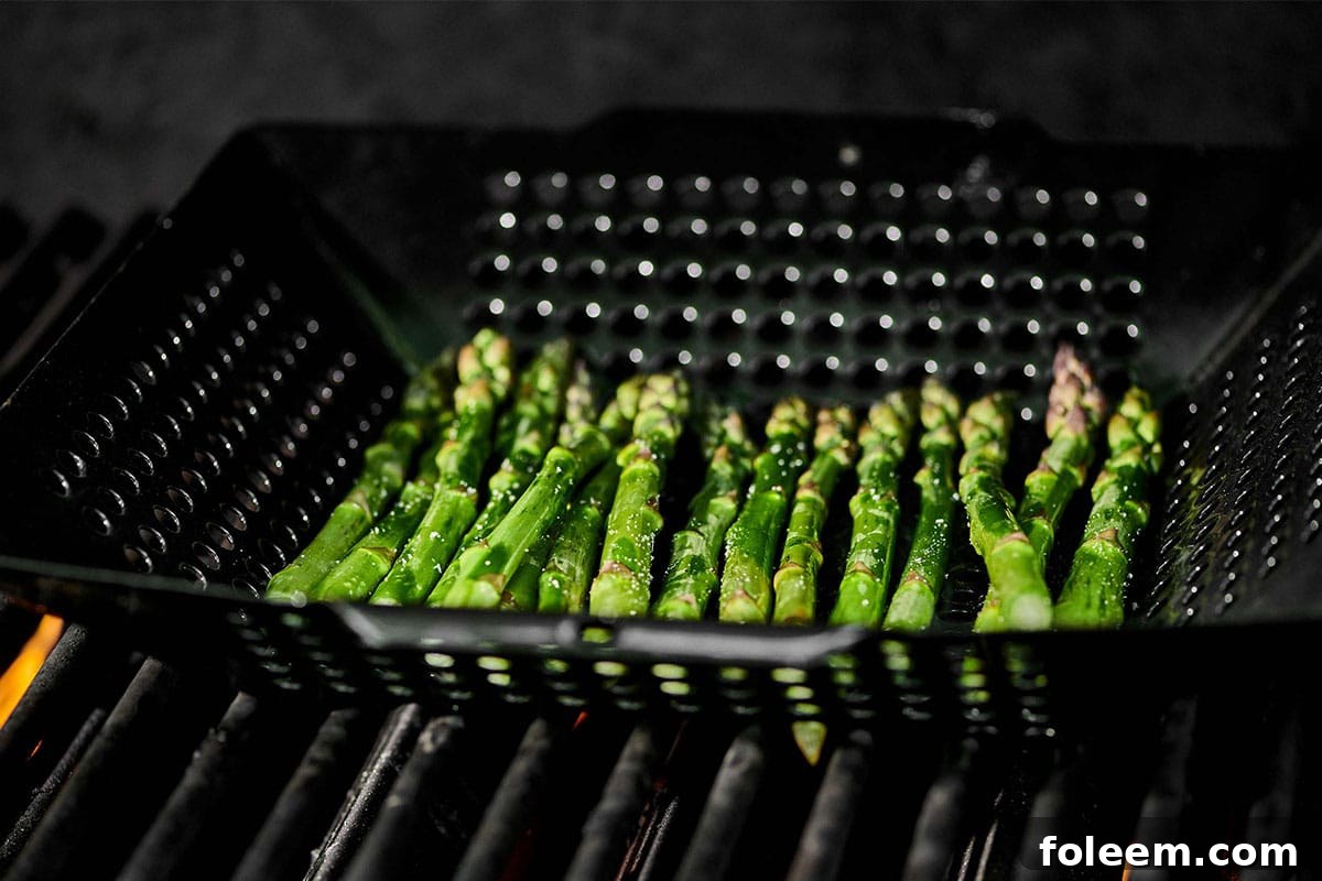 Grilling asparagus in basket.