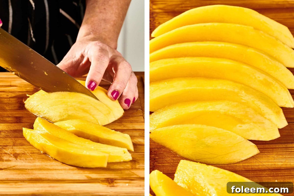 Woman cutting mango into slices.