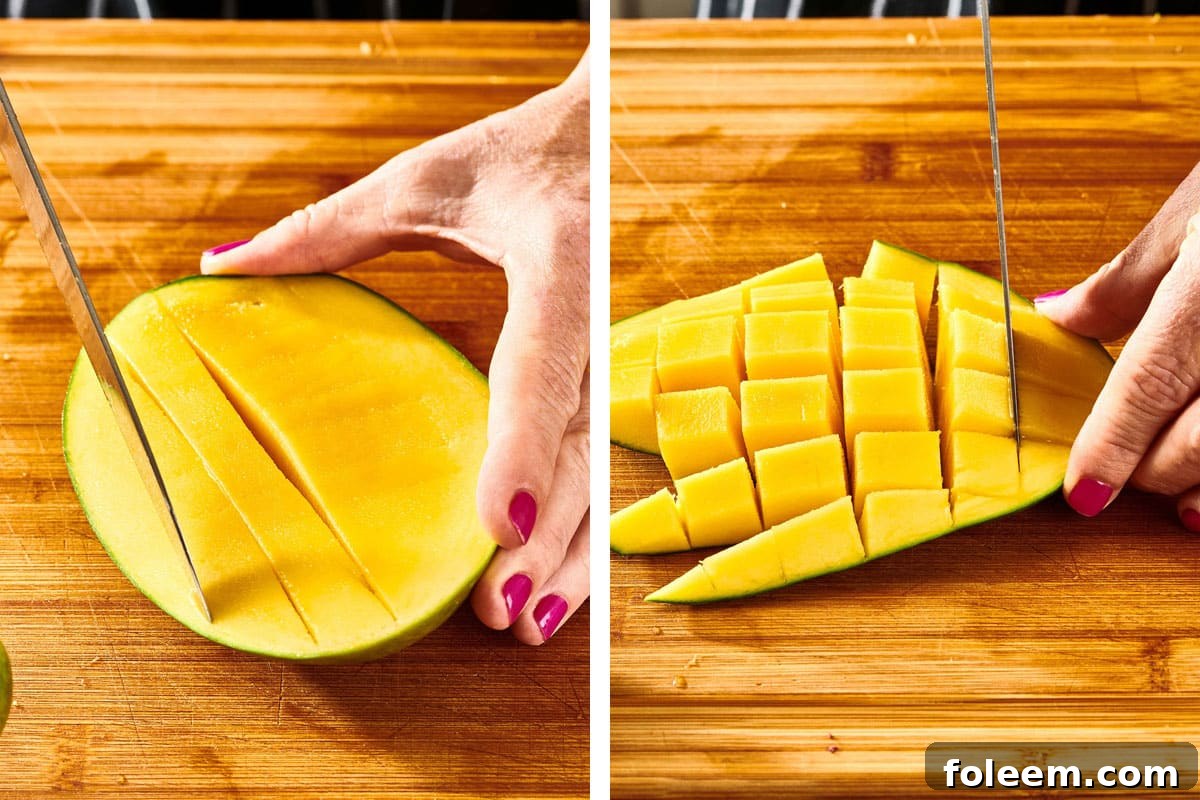 Woman scoring flesh of fresh, unpeeled mango with knife.