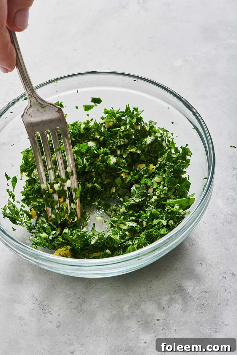 Mixing gremolata with fresh parsley and lemon zest.