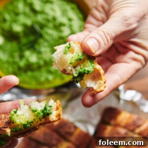 Garlic bread with spinach-parsley pesto between slices.