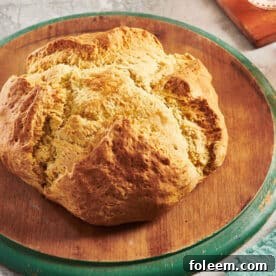 Loaf of Irish Soda Bread on a wooden board.