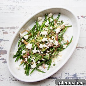Sautéed Haricot Verts with Red Onions and Shallots topped with crumbled cheese.