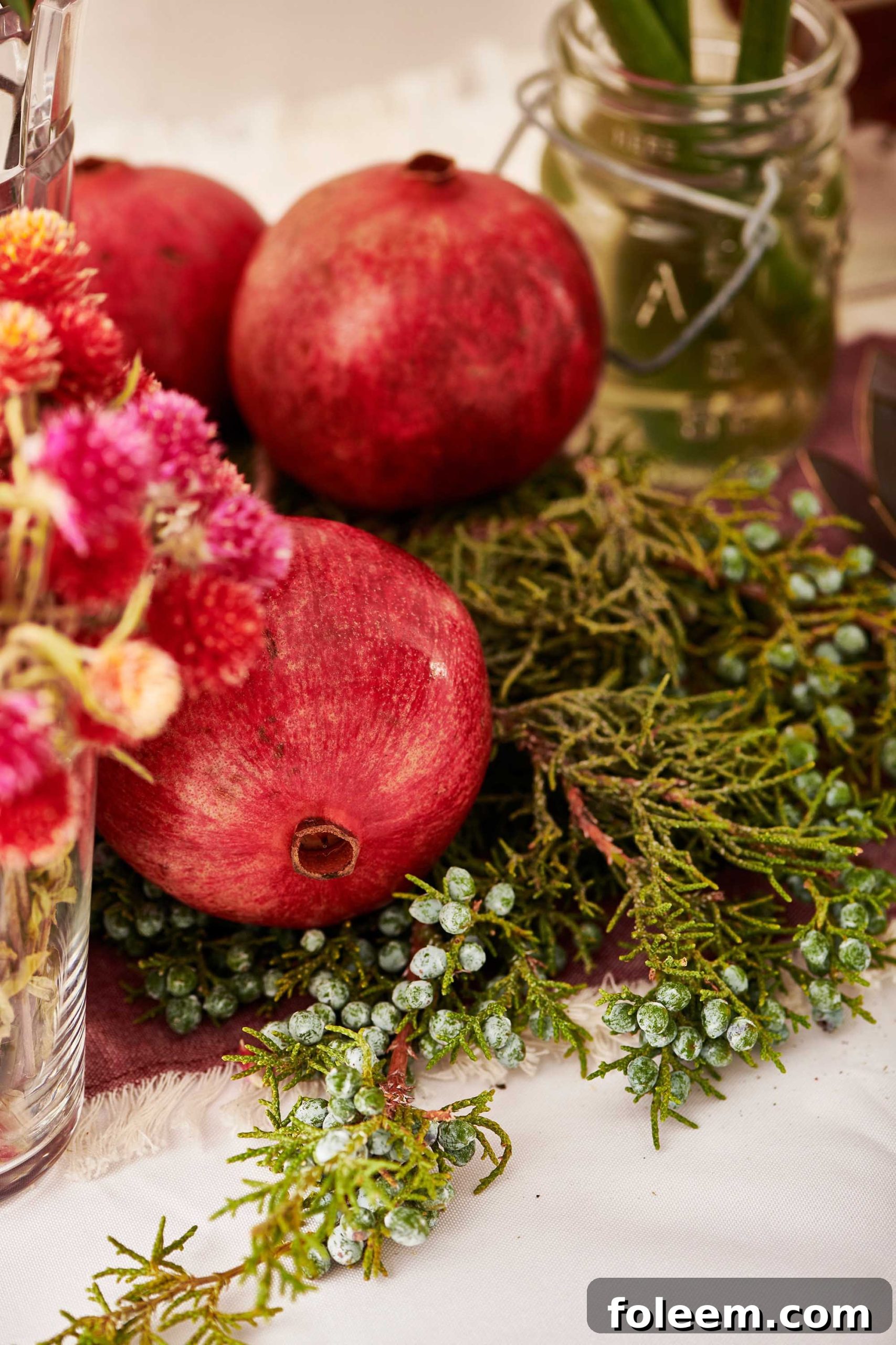 Whole pomegranates on branches of juniper.