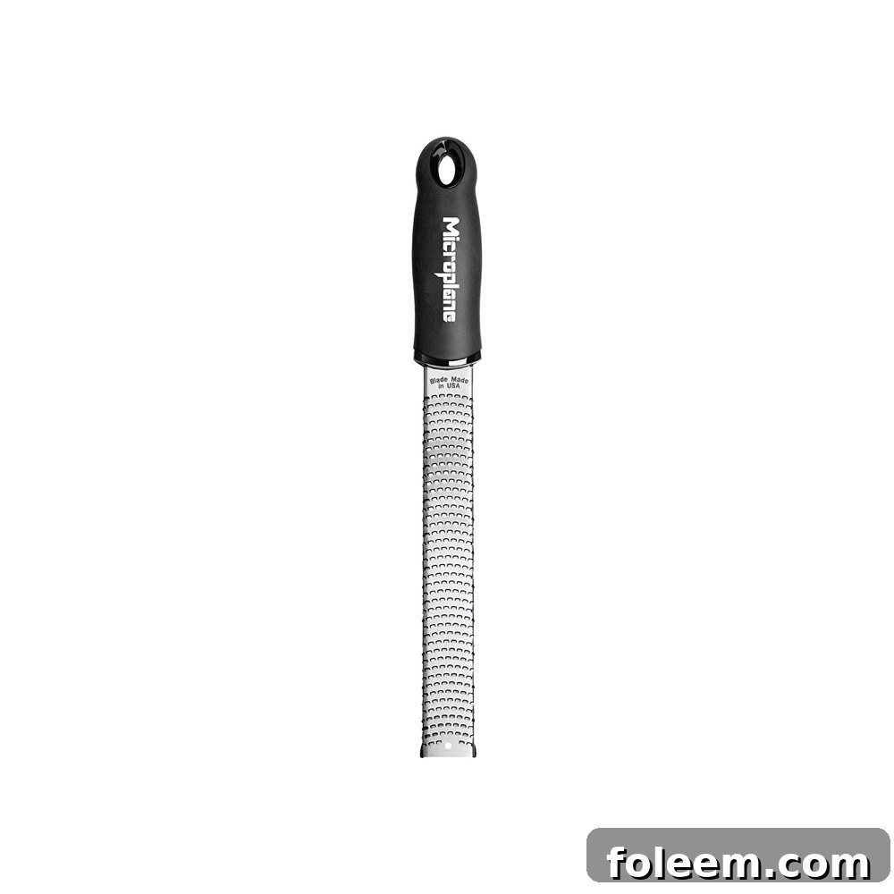 Microplane grater with a black handle.