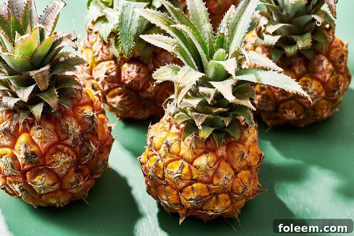 Baby pineapples on green table.