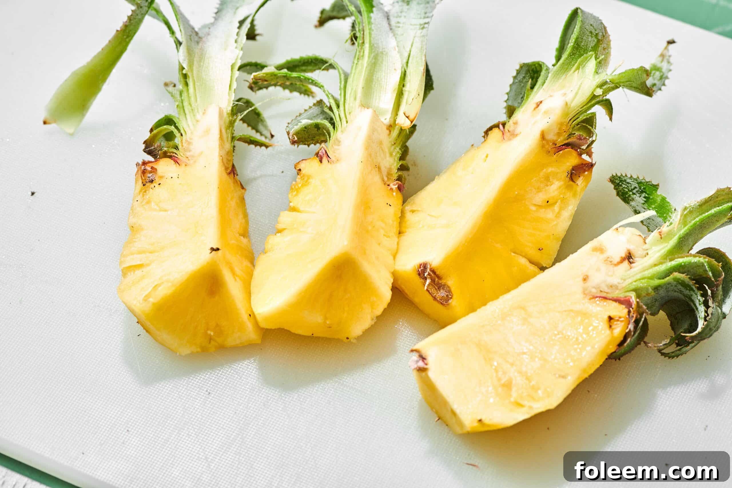 Sliced Baby Pineapple wedges on table.
