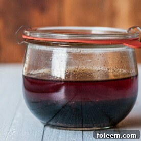 Spicy Sesame Asian Marinade in small jar on wood table.