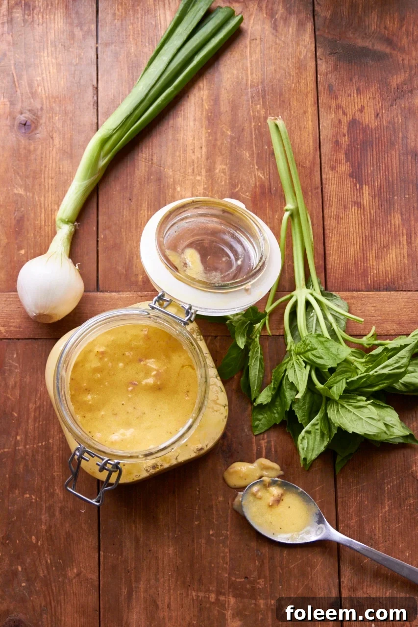 Dijon, Garlic and Lemon Marinade  in jar with onion and basil.
