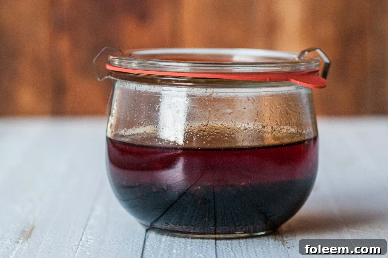 Spicy Sesame Asian Marinade in small jar on wood table.