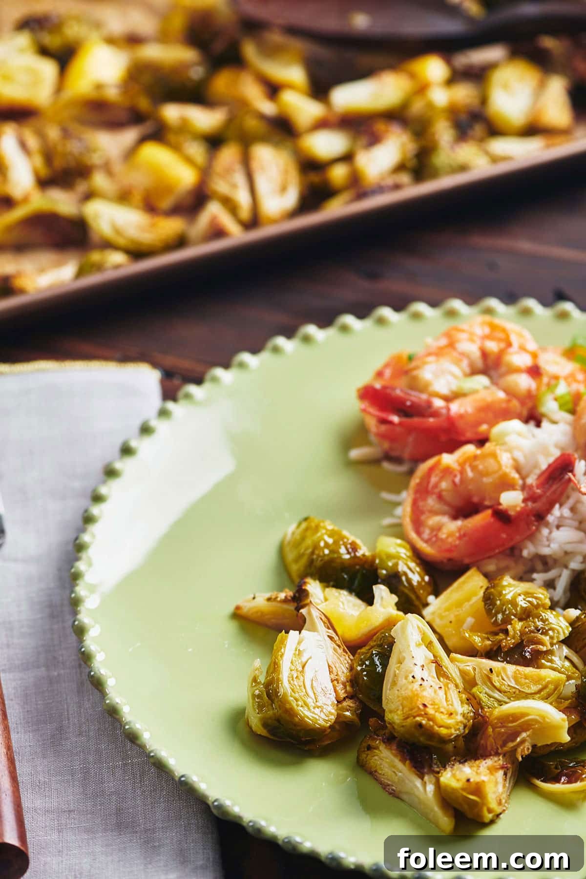 Roasted Lemon Brussels Sprouts on green plate with shrimp.