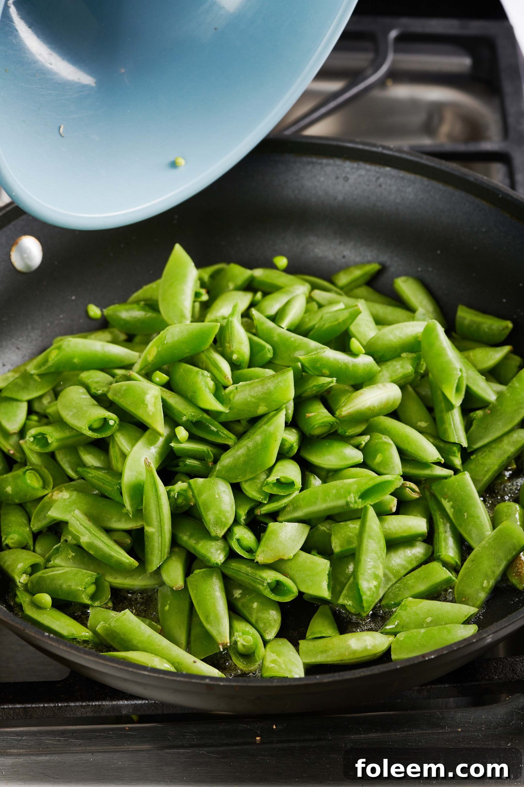 Sliced sugar snap peas in a pan.