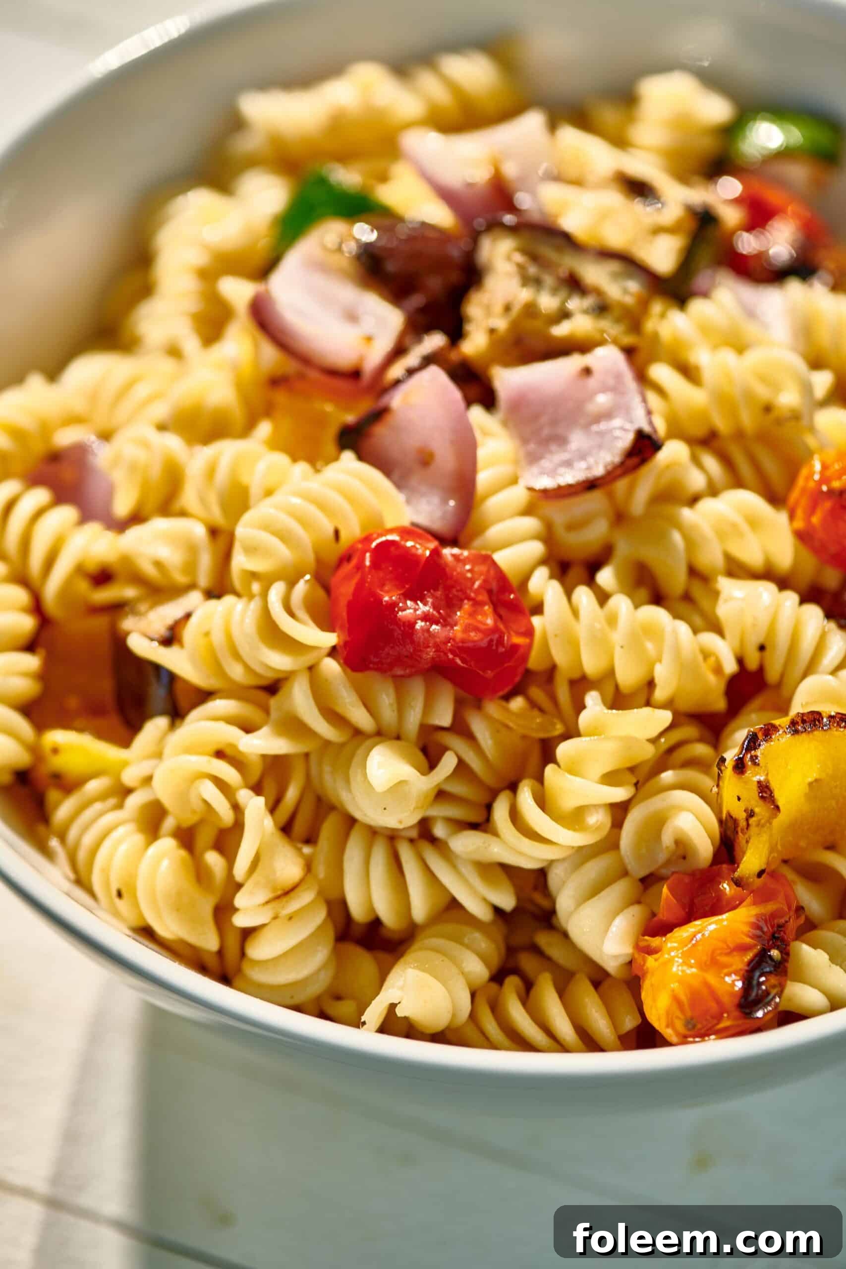Grilled Vegetable Pasta Salad in bowl on picnic table.